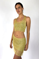 Light gold chain racerback top with bralette by Natalia Fedner, shown from the side view, featuring a sleek, metallic finish.