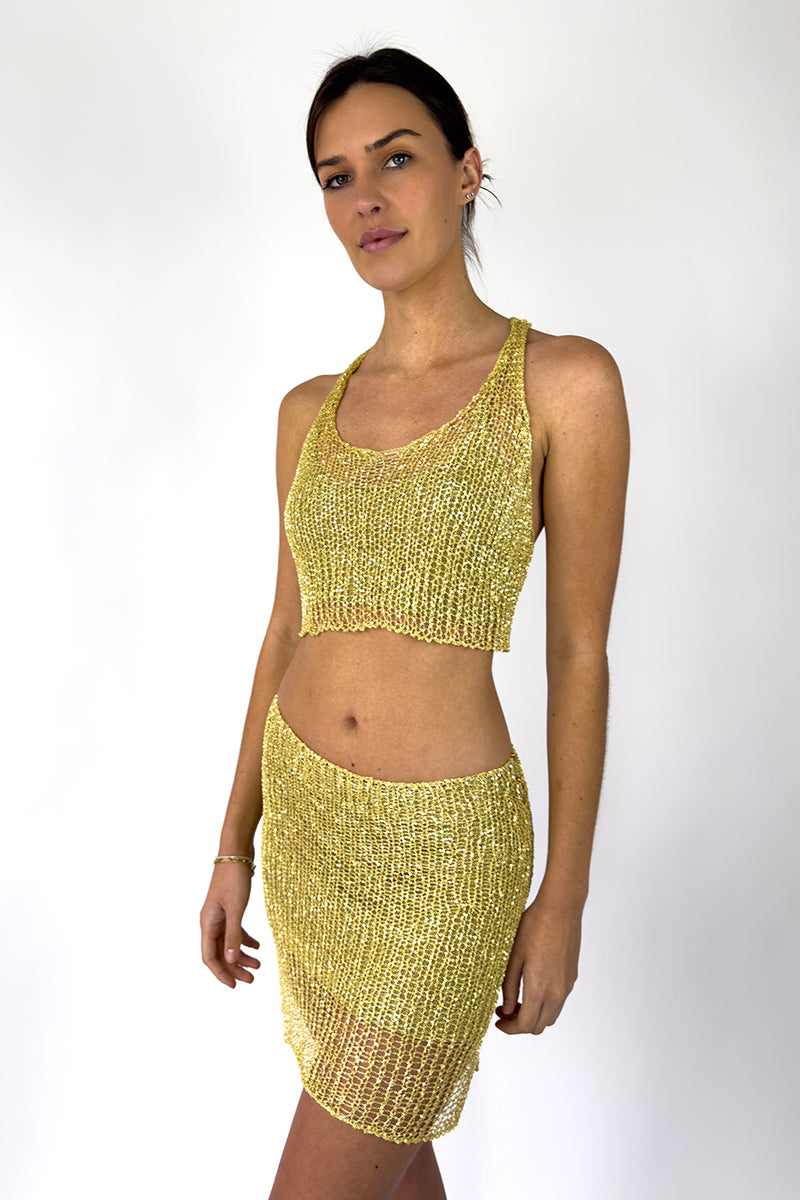 Light gold chain racerback top with bralette by Natalia Fedner, shown from the side view, featuring a sleek, metallic finish.