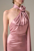 Light pink satin halter gown by I.H.F with cross detail and pleated drape, showcasing elegant design and smooth fabric.