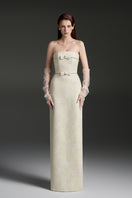 Light yellow strapless lacquered brocade gown by I.H.F Studio with pearl and crystal chain embellishments.