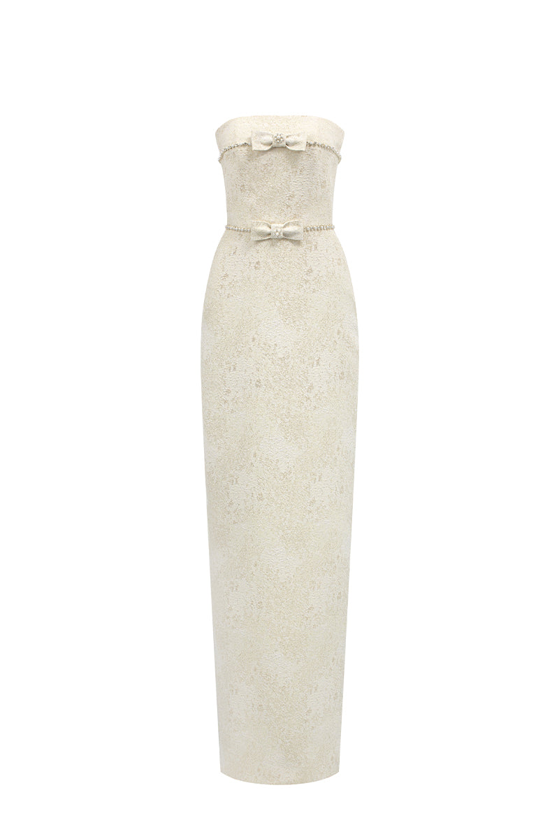 Light yellow strapless lacquered brocade gown by I.H.F Studio with pearl and crystal chain embellishments, elegant column style.