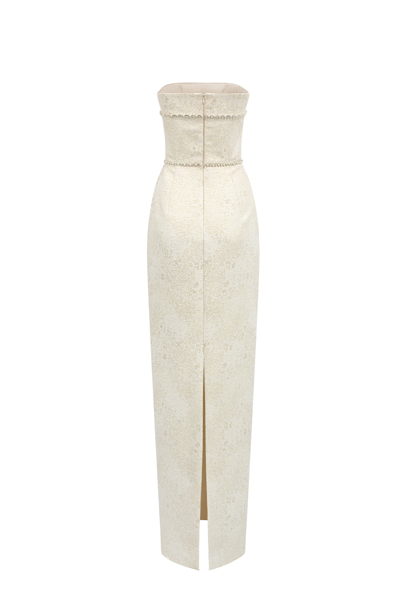 Light yellow strapless lacquered brocade gown by I.H.F Studio featuring pearl and crystal chain embellishments.