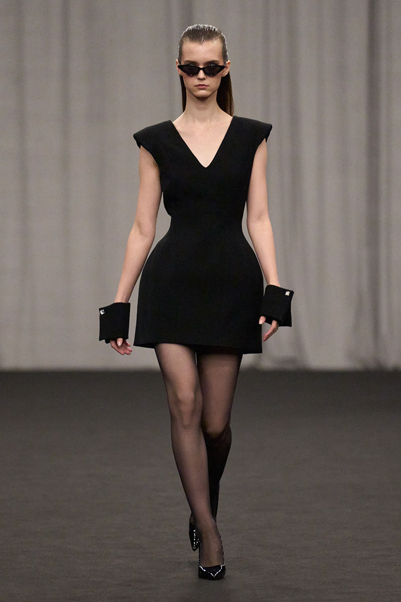 Lili Blanc luxe tailored sleeveless midi dress in elegant fabric, featuring a fitted bodice and flowing skirt.