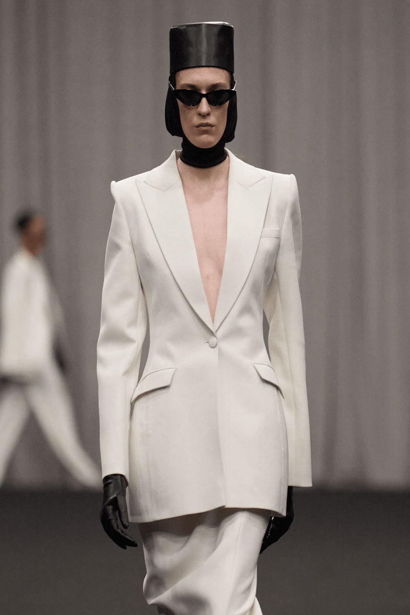 Lili Blanc sleek single-breasted blazer in a classic cut, shown in a close-up view highlighting the tailored fit and fabric details.
