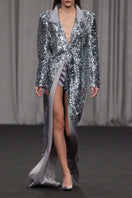 Lili Blanc sequin longline coat with shiny embellishments, tailored fit, and elegant design, worn over a stylish outfit.
