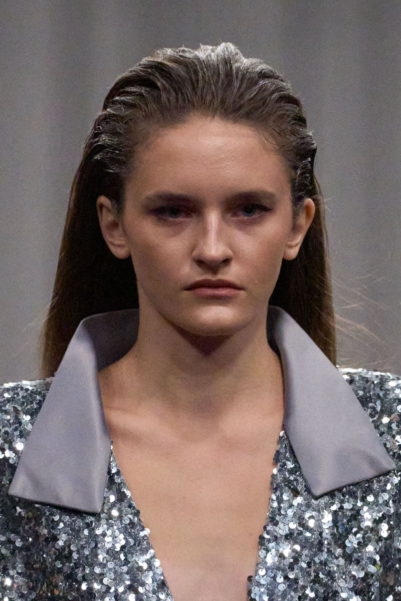 Lili Blanc sequin longline coat featuring shimmering sequins and a sleek silhouette, stylishly displayed on a hanger.