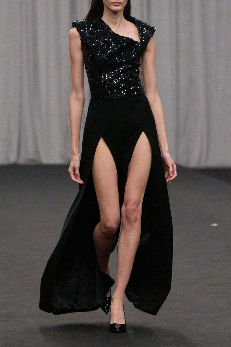 Lili Blanc asymmetrical sleeveless jumpsuit featuring a modern design and stylish fit, showcased on a model.