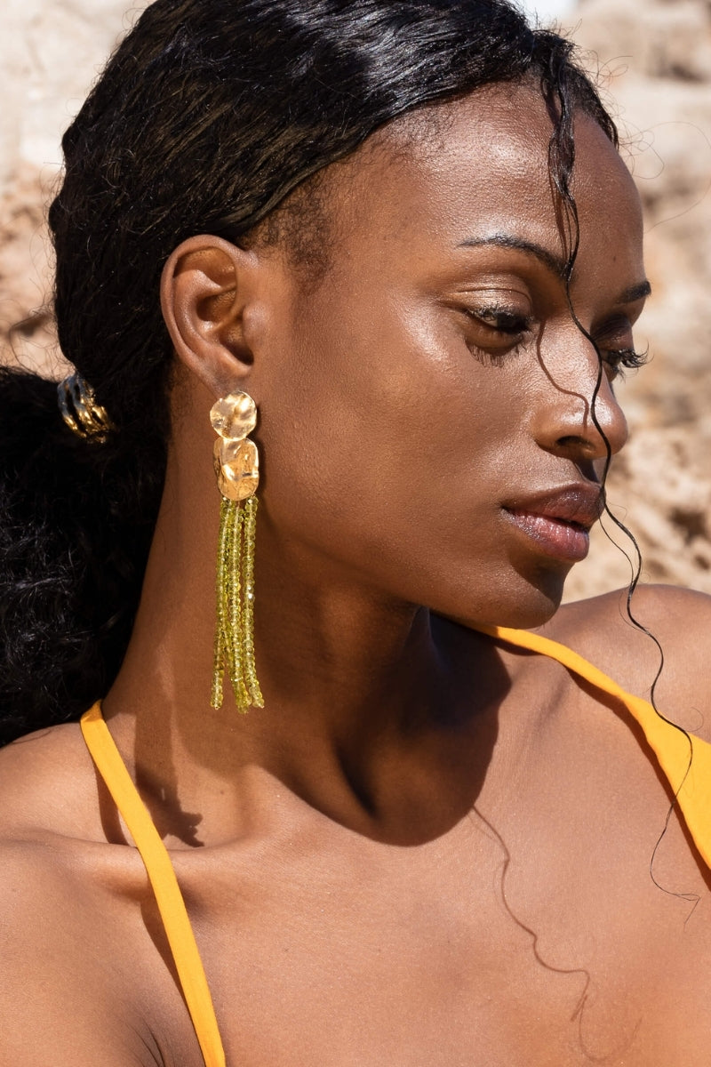 Lavani Jewels Liliana green earrings featuring intricate gold detailing and vibrant green gemstone accents.