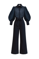 Navy blue Lilianne jumpsuit by ANA + MARIA featuring a fitted waist and wide-leg pants, displayed on a ghostly mannequin.