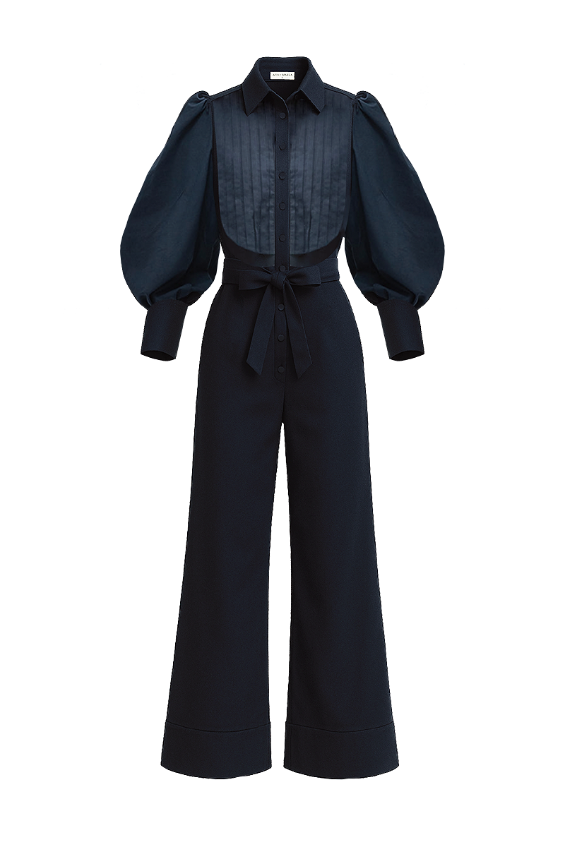 Navy blue Lilianne jumpsuit by ANA + MARIA featuring a fitted waist and wide-leg pants, displayed on a ghostly mannequin.