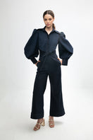 Navy blue Lilianne jumpsuit by ANA + MARIA, featuring a stylish, tailored design and wide-leg pants on a model.