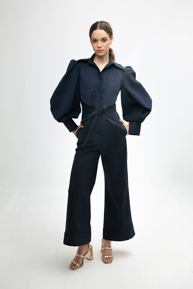 Navy blue Lilianne jumpsuit by ANA + MARIA, featuring a stylish, tailored design and wide-leg pants on a model.