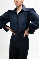 Navy blue Lilianne jumpsuit by ANA + MARIA displayed on a model, featuring a stylish, fitted design with wide-leg pants.