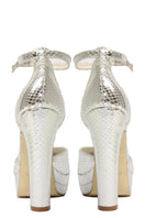 Silver platform heels by Terry de Havilland with chunky heel and open toe, showcased from a side angle.