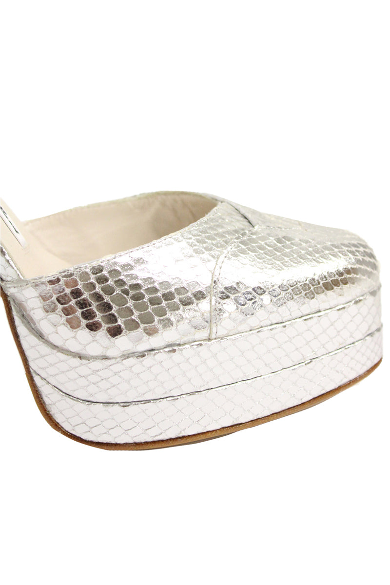 Silver platform heels by Terry de Havilland featuring a sleek design with chunky heels and stylish strappy details.