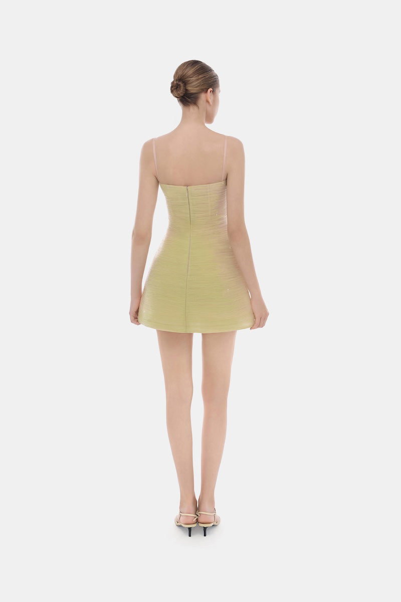 Lime crinkled mini dress by Montsand, featuring a fitted silhouette and sleeveless design, shown on a model.