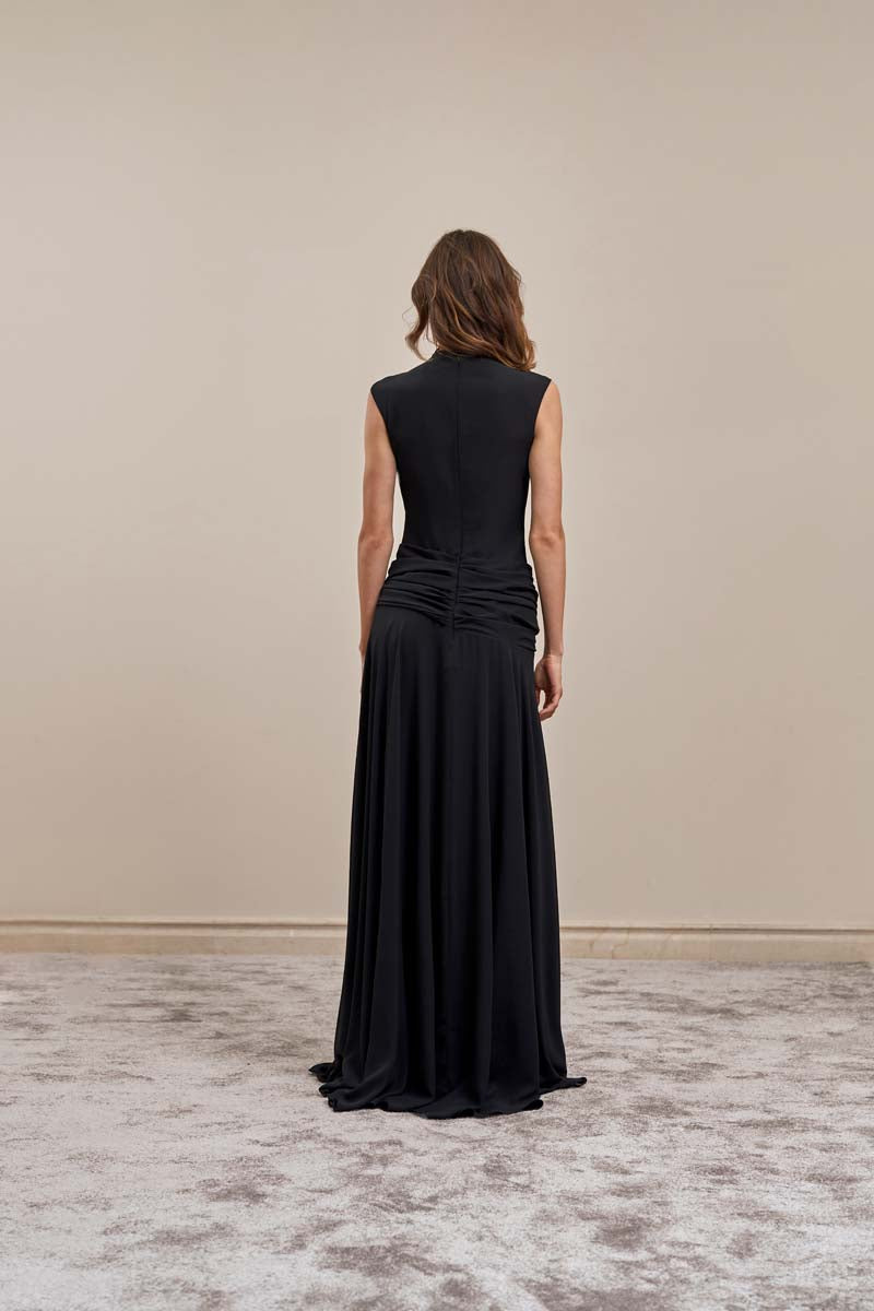 Black YASSMIN SALEH Line Gown maxi dress shown from the back, featuring a flowing silhouette and elegant design.