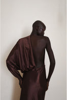 Close-up of the back of a brown LINGER gown by YASSMIN SALEH, featuring elegant maxi dress details and soft fabric.