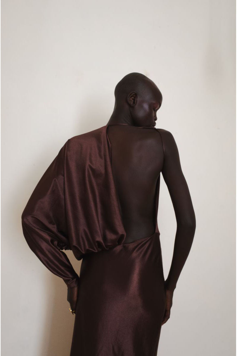 Close-up of the back of a brown LINGER gown by YASSMIN SALEH, featuring elegant maxi dress details and soft fabric.