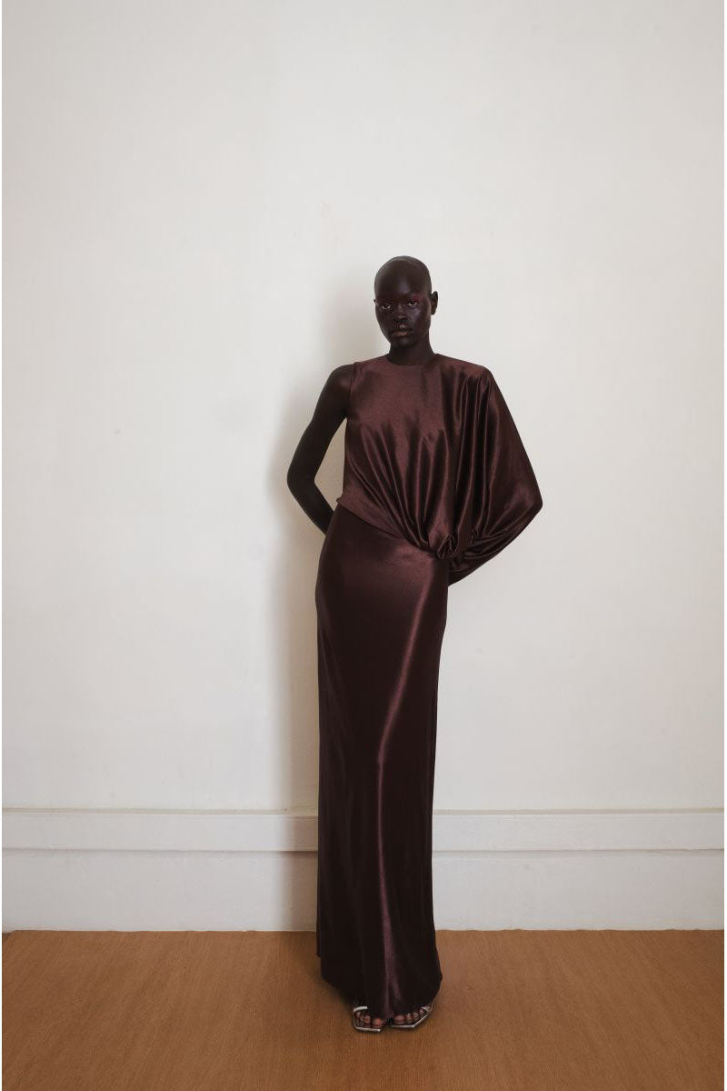 Brown Linger gown by YASSMIN SALEH, a stylish maxi dress with a flowing silhouette, shown from the front in the image.
