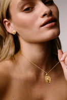 Gold lion stud earrings by Freya Rose featuring detailed lion head designs with a polished finish.