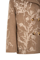 Nadya Shah Louis Biscuit pea coat in beige with classic double-breasted design and large lapels, displayed on a hanger.