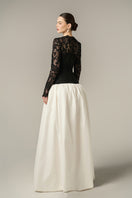 Black and white guipure lace and taffeta gown by I.H.F with long sleeves and a bubble hem, elegant evening ball gown.