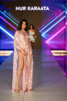 Nur Karaata Palm House Maxi Dress displayed on a model, showcasing its flowing fabric and stylish design.