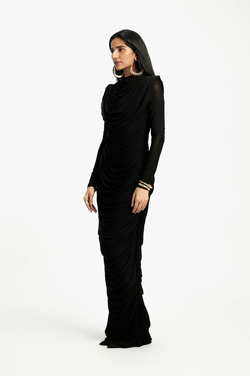 Deme By Gabriella Grace long sleeve maxi dress in flowy fabric, featuring a fitted bodice and elegant full-length skirt.