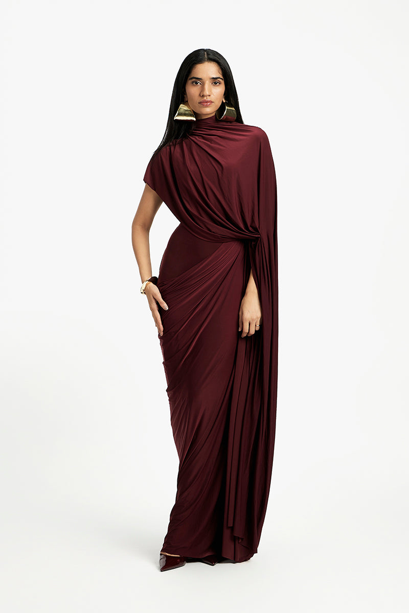 Deme By Gabriella Daphne draped maxi dress in flowing fabric, featuring elegant design and full-length silhouette.