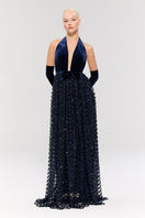 Nur Karaata Crowlight gown displayed on a model, featuring elegant design and flowing fabric suitable for formal events.