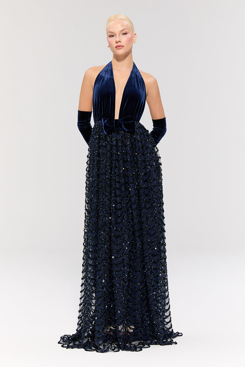 Nur Karaata Crowlight gown displayed on a model, featuring elegant design and flowing fabric suitable for formal events.