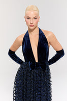 Nur Karaata Crownlight gown featuring elegant fabric and intricate design, displayed on a mannequin in a stylish setting.