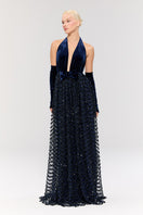 Nur Karaata crowlight gown featuring intricate lace details and flowing fabric, perfect for elegant formal occasions.