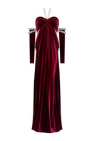 Elegant red gown by Nur Karaata from the Royal Ancestry collection, featuring intricate detailing and flowing fabric.