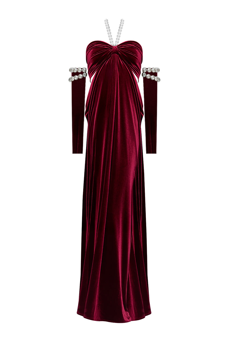 Elegant red gown by Nur Karaata from the Royal Ancestry collection, featuring intricate detailing and flowing fabric.