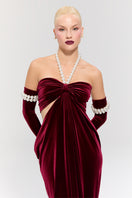 Elegant red gown from Nur Karaata's Royal Ancestry collection, featuring intricate design and flowing fabric.