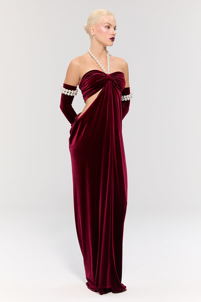 Elegant royal ancestry red gown by Nur Karaata, featuring intricate details and flowing fabric, perfect for formal occasions.