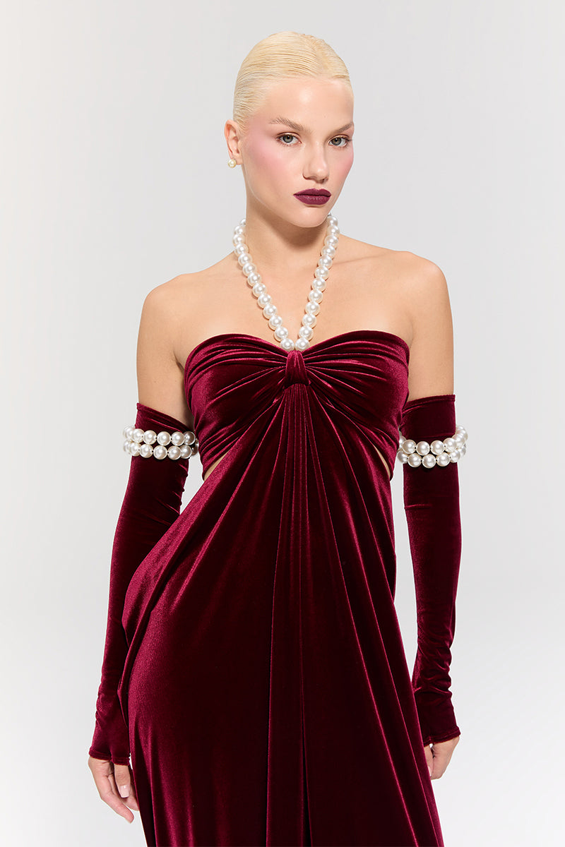 Elegant red gown by Nur Karaata from the Royal Ancestry collection, featuring intricate details and flowing fabric.
