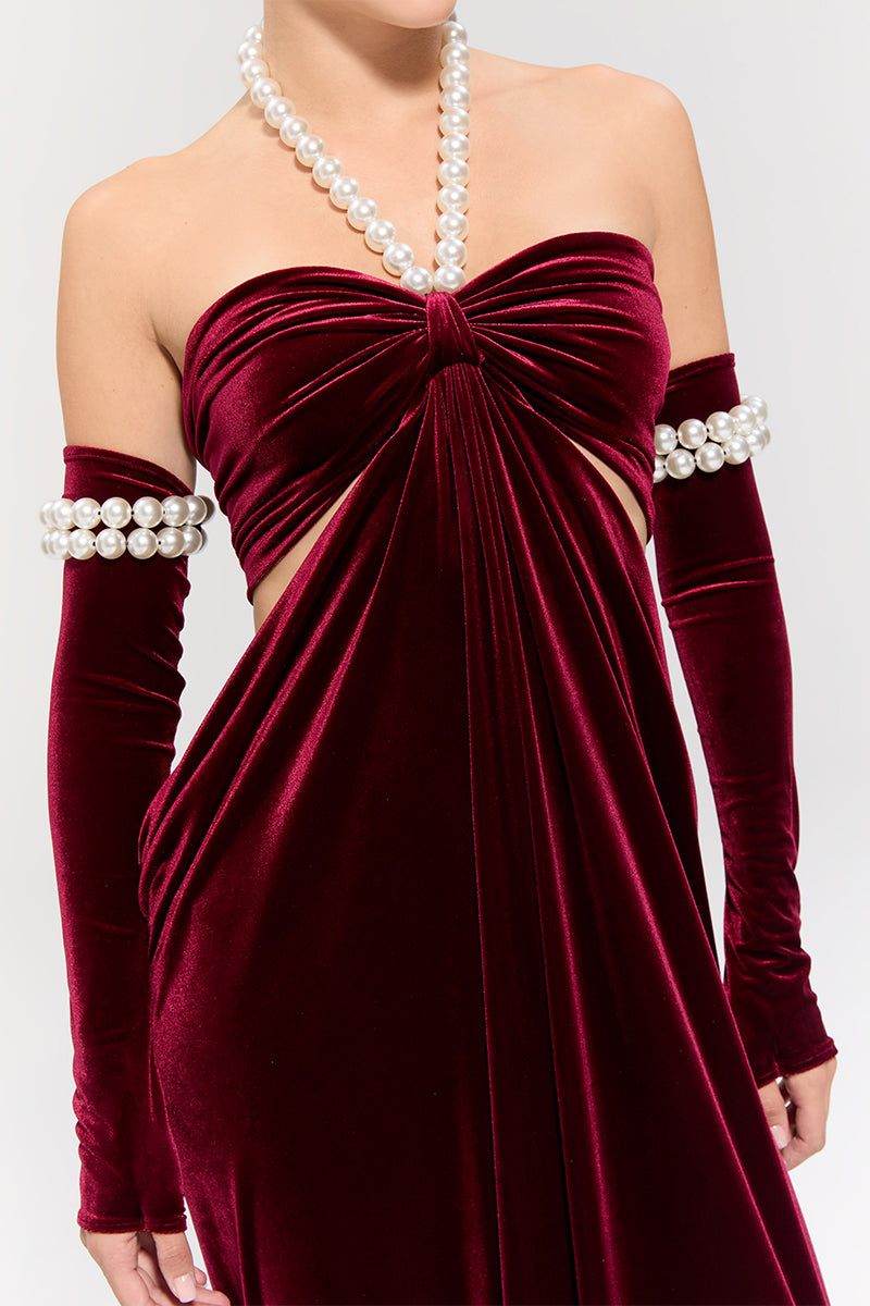 Elegant red gown by Nur Karaata from the Royal Ancestry collection, featuring intricate detailing and a flowing silhouette.
