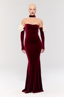Nur Karaata Versailles Rose Burgundy gown displayed on a model, featuring elegant flowy fabric and intricate detailing.