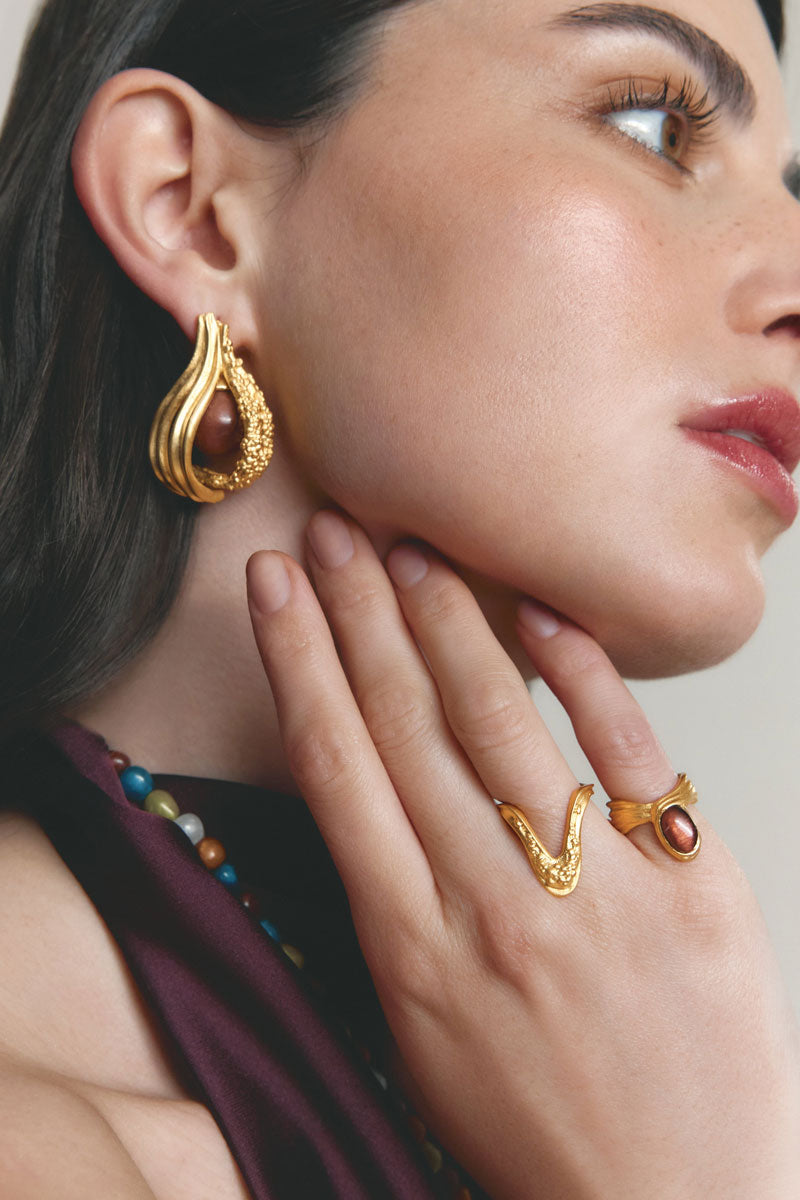 Gold and pearl interchangeable loop hoop earrings by Jude Benhalim, featuring stylish, modern jewelry with hanging pearl accents.