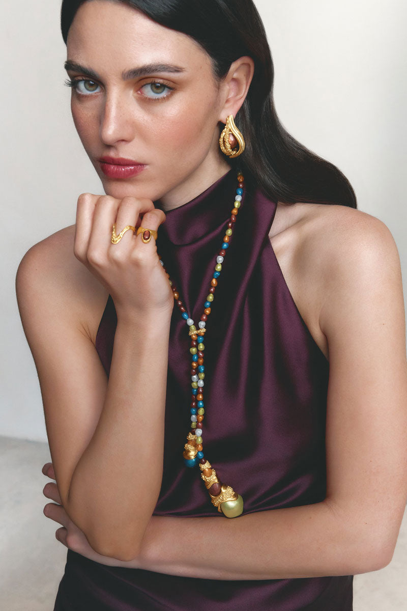Gold and pearl interchangeable loop hoop earrings by Jude Benhalim, featuring stylish gold hoops with white pearl accents.