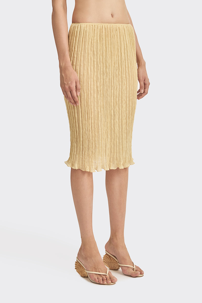 Yellow Lotus pleated knee-length midi skirt by Stolen Stores, showcasing its flowy fabric and stylish pleats.