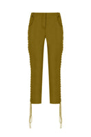 Green low-rise eyelet capri pants by Tayfun Kaba, featuring a stylish cut and eyelet detailing, shown on a model.