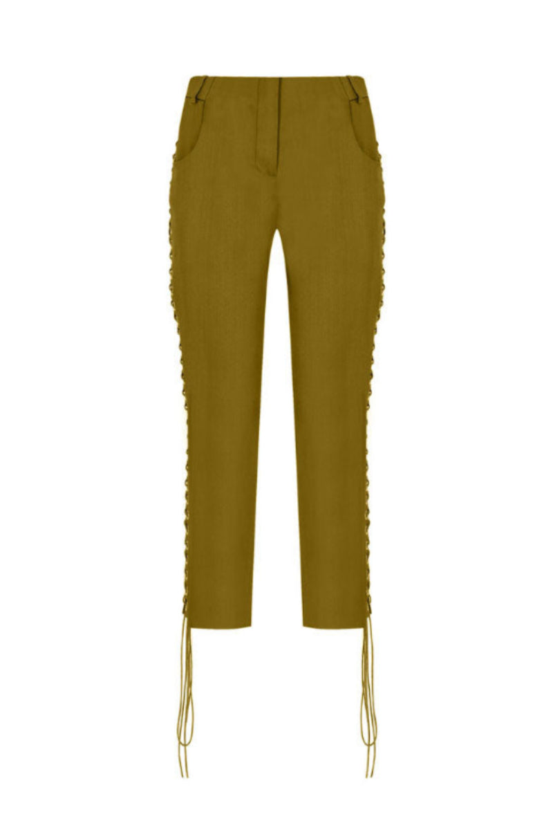 Green low-rise eyelet capri pants by Tayfun Kaba, featuring a stylish cut and eyelet detailing, shown on a model.