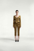 Green eyelet low-rise capri pants by Tayfun Kaba, showcasing a stylish, breathable design with a relaxed fit.