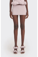Purple polka dot low waist mini skirt from Stolen Stores, showcasing its fitted design and playful pattern.