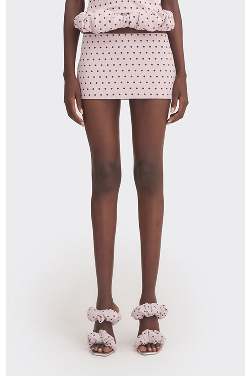Purple polka dot low waist mini skirt from Stolen Stores, showcasing its fitted design and playful pattern.