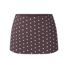 Dark brown polka dot mini skirt with a low waist, stylish and trendy, by Stolen Stores.
